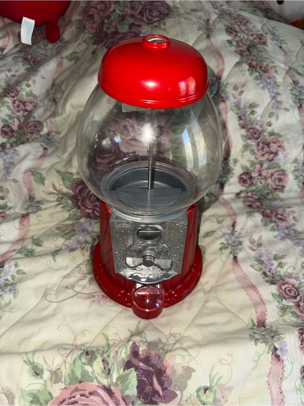 vintage-style red cast-metal and glass gumball machine